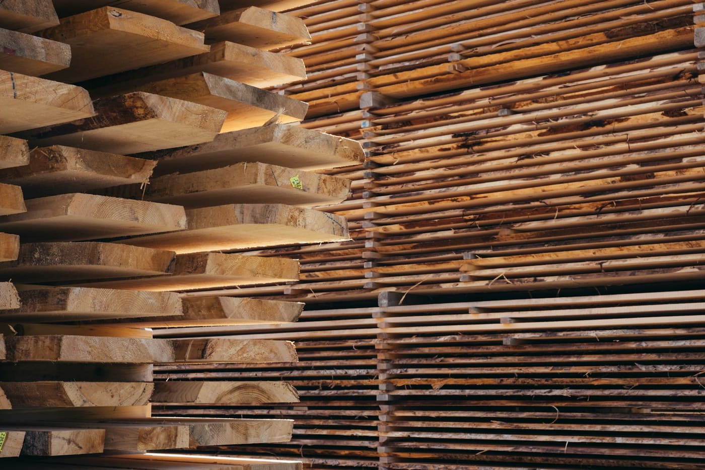 Sawn timber stacked in layers in a lumber yard.